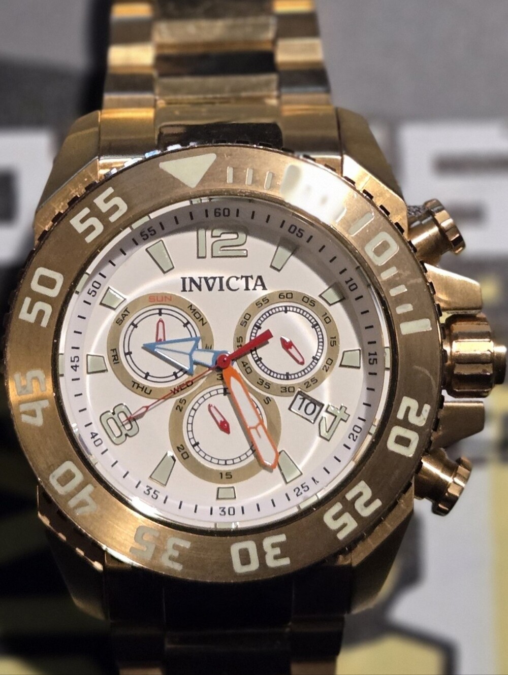 Invicta Gold and White Chronograph Watch with Colorful Hands